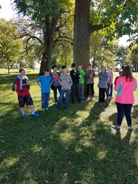 Students standing around tree (PBIS Celebration/DNR Day! Fall 2017)