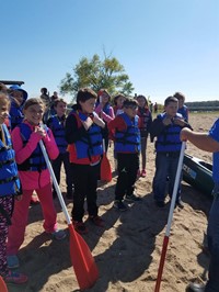 Students on beach with life jackets and oars (PBIS Celebration/DNR Day! Fall 2017)