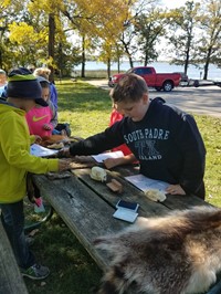 Students identifying furs on picnic table (PBIS Celebration/DNR Day! Fall 2017)