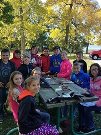 Students identifying furs on picnic table (PBIS Celebration/DNR Day! Fall 2017)