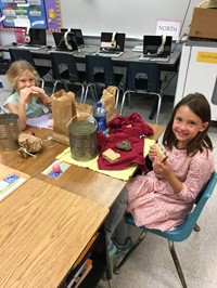 Students eating their pioneer lunch (2nd grade Pioneer Day - Fall 2017)