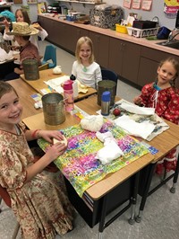 Students eating their pioneer lunch (2nd grade Pioneer Day - Fall 2017)