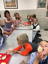Students eating their pioneer lunch (2nd grade Pioneer Day - Fall 2017)
