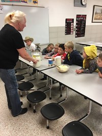Students watching a pioneer cooking demonstration (2nd grade Pioneer Day - Fall 2017)