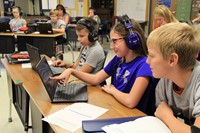 Group of students looking at computer