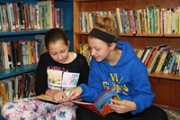 Two girls reading books