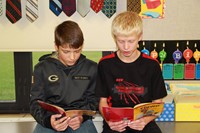 Two boys reading books