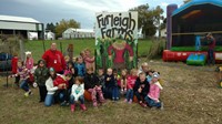 students by a Furleigh Farms sign