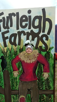 student in a scarecrow photo display