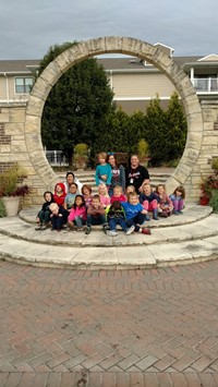 students sitting under an arch