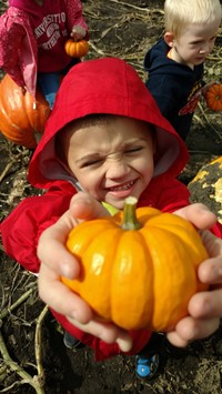student holding a pumpkin