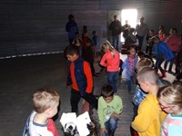 GHV First grade students visiting farm and standing in grain bin