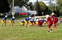 A group of junior high football players playing in a game