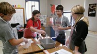 Four students conducting a science experiment