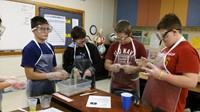 A group of intermediate students conducting a science experiment