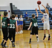 A Junior High boy shooting a basketball