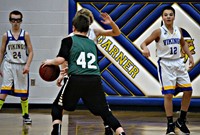 A group of boys playing in a basketball game