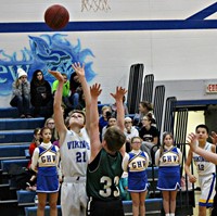 A boy shooting during a basketball game