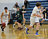 A group of basket ball players with one player dribbling up the court