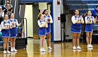 A group of cheerleaders cheering during a basketball game