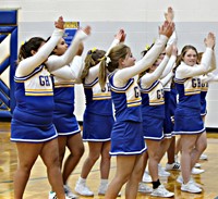 A group of cheerleaders cheering during a basketball game