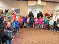 Elementary students singing Christmas carols at the local bank