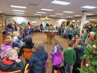 Elementary students singing Christmas carols at the local bank