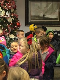 Students singing by a Christmas tree