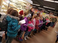 Students singing at the grocery store