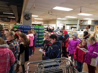 Students singing at the grocery store