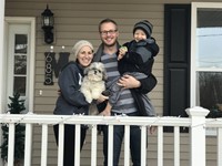 Principal and his family standing on his porch