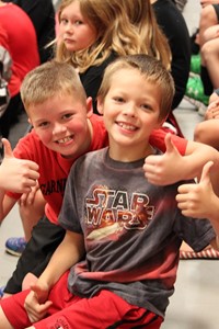 Elementary students in the stands at a pep rally