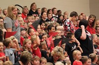 Elementary students in the stands at a pep rally