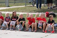 Students sitting on curb waiting for parade