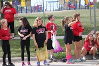 Students standing near curb waiting for parade to begin