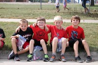 Students sitting on curb waiting for parade