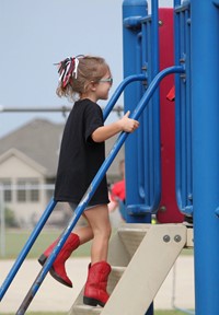 Elementary student climbing slide