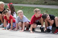 Students sitting on curb waiting for parade