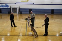 A student throwing a toy to the dog after he found the drug sample