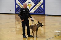 A police officer explaining the purpose of police dogs