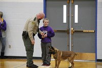 A student preparing to run the police dog through his training course