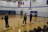 Law enforcement officers explaining the purpose of police dogs