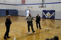 Law enforcement officers explaining the K-9 demonstration to GHV students