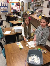 Elementary students working with Play-Doh