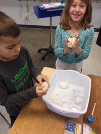 Elementary students working with Play-Doh