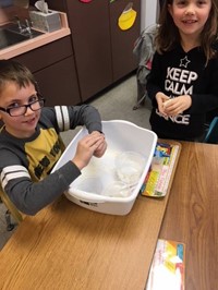 Elementary students working with Play-Doh