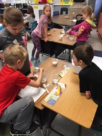 Elementary students working with Play-Doh