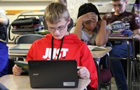 A boy doing an assignment on his Chromebook