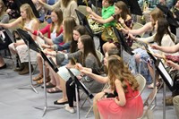 A group of junior high band students students getting ready to play