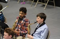 Two junior high boys playing the saxophone